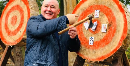 Man enjoying axe throwing
